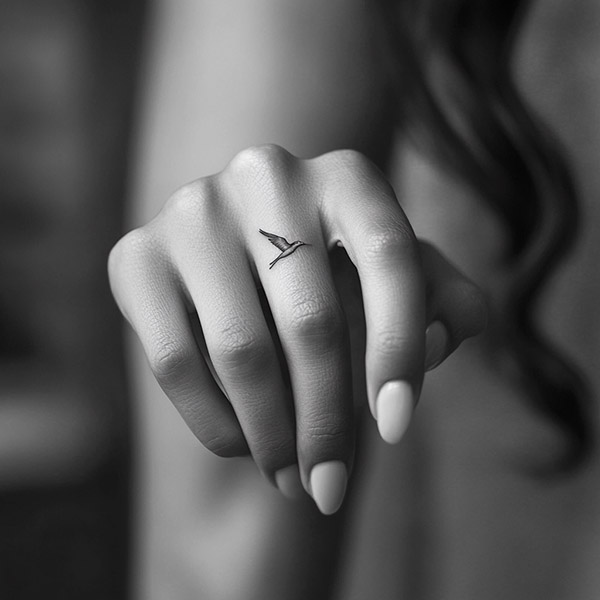 Small fine line finger tattoo